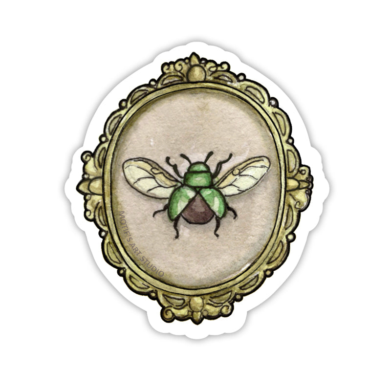 Bright green beetle with wings framed in an ornate gold frame.