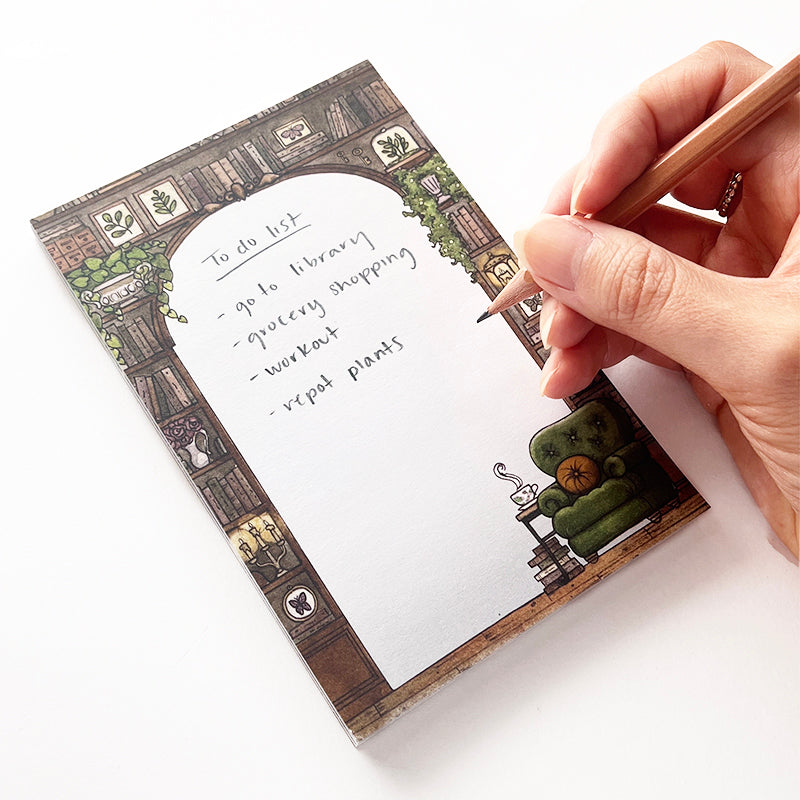 Notepad of someone writing a list on it.