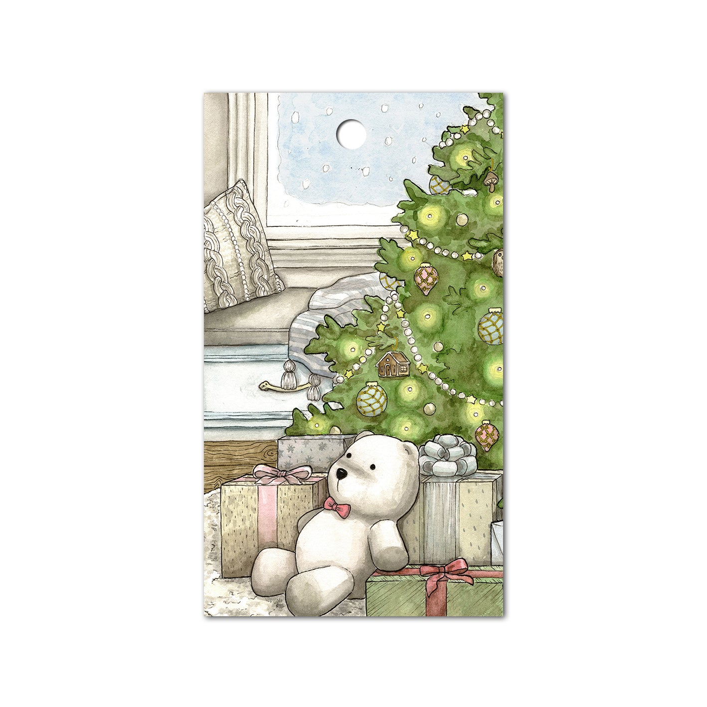 Gift tag with a polar bear stuffed animal sitting underneath a Christmas tree.