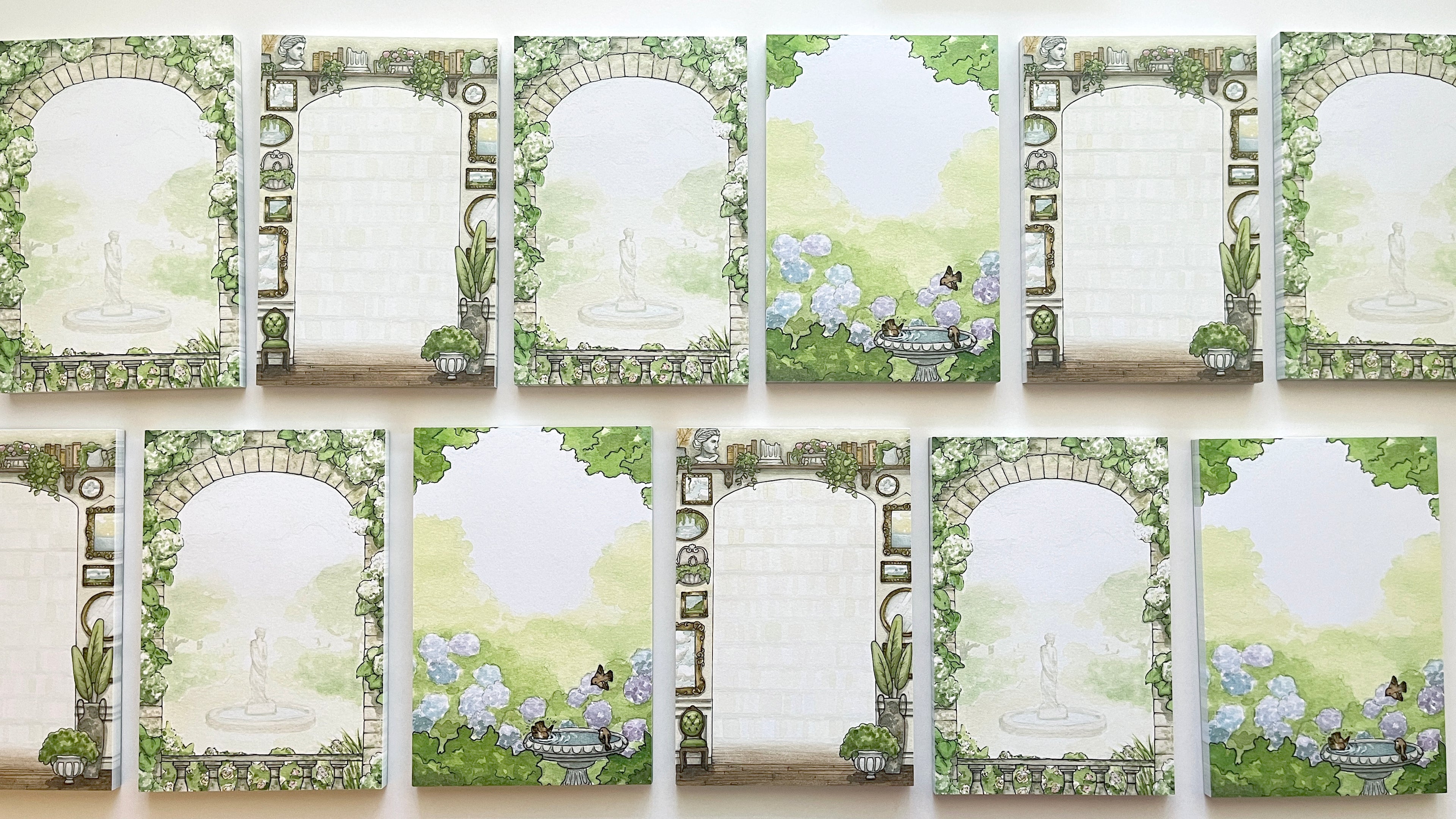 Multiple small notepad designs featuring a garden, a bird bath, and a library with a gallery wall.
