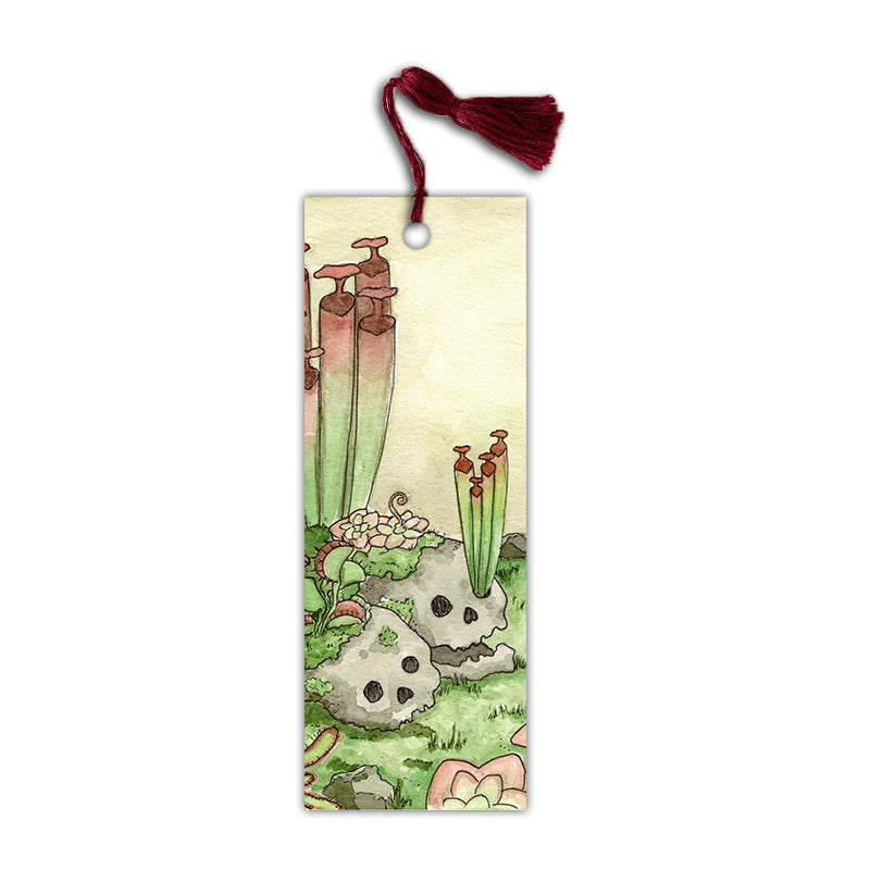 Bookmark with a red tassel matching the red carnivorous plants in the design alongside cute skulls.