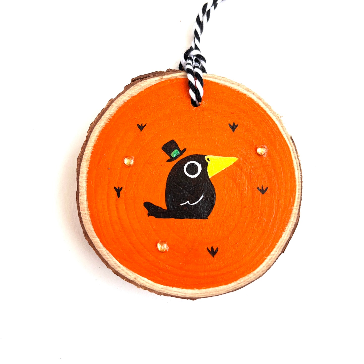 wooden ornament with a cute black baby crow on an orange background with orange heart rhinestones
