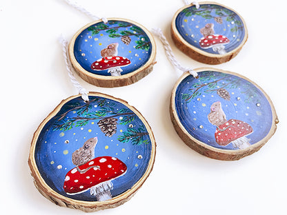 Angled shot of wooden ornaments with the same mouse and mushroom design. You can see the rhinestones sparkling at this angle.