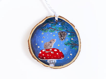 mouse sitting on a large red mushroom, gazing at a mini pinecone in a tree. It's surrounded by lights and several sparkly 3d rhinestones.