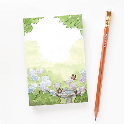 4x6 notepad with garden design next to a pencil for size reference.