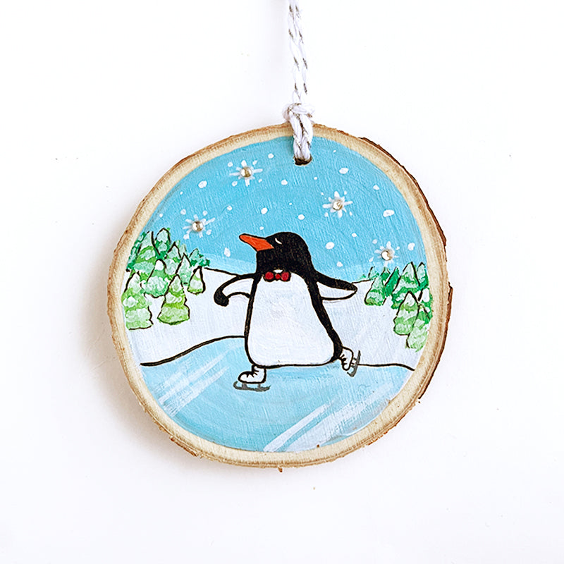 Ice skating penguin dancing on a frozen lake with snowy tree in the background and snowflakes in the sky.