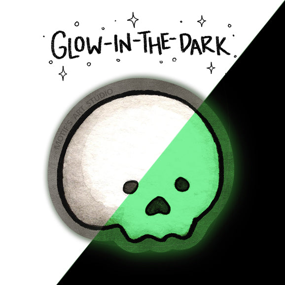 A sticker with a cartoon skull-like face outlined in black. The product is shown split diagonally: half in a pale off-white tone and half glowing bright green, with the text 'GLOW-IN-THE-DARK' above.
