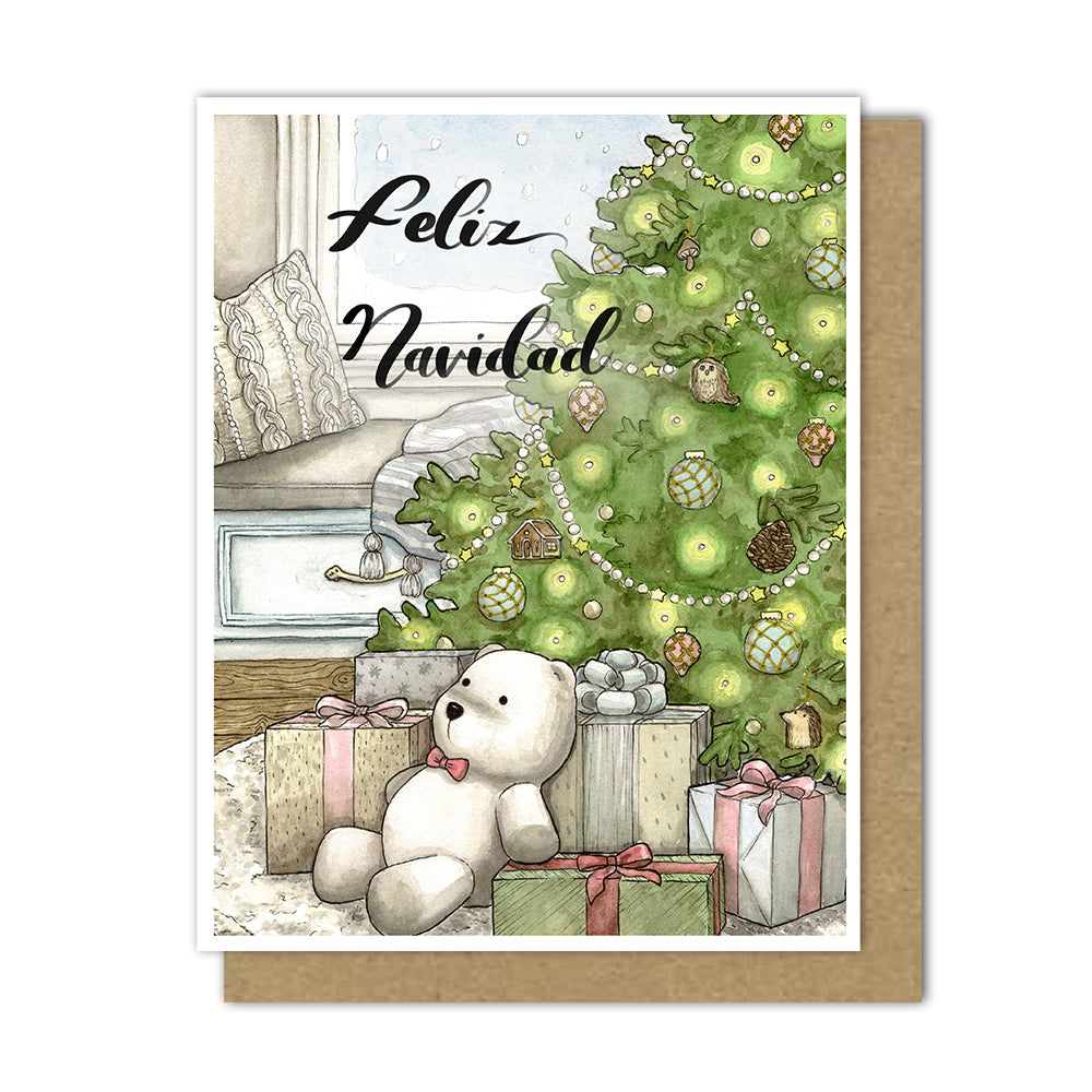 Greeting card with lush christmas tree with presents under the tree and a polar bear stuffed animal. A knit pillow and blanket sit in the background on a bench looking out a snowy window.