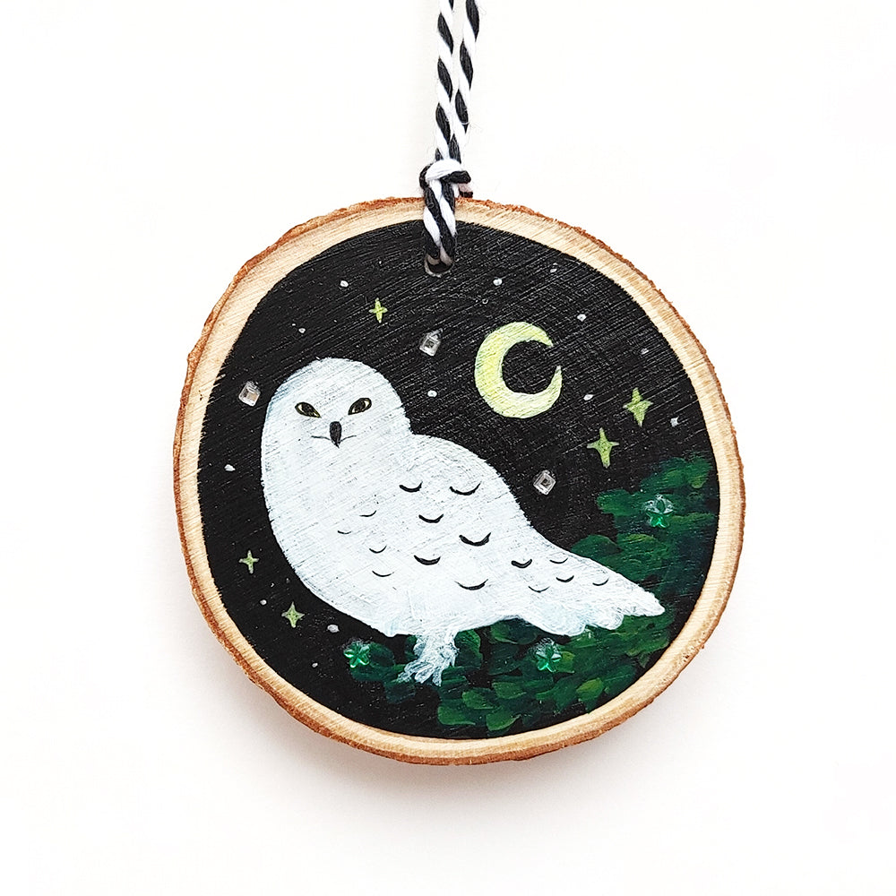 Harry Potter's beloved hedwig on a black wooden ornament with a moon, stars, and rhinestones